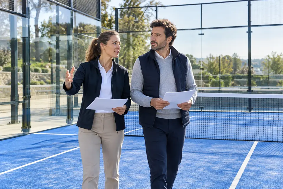 Illustrative scene of specialists inspecting a padel facility